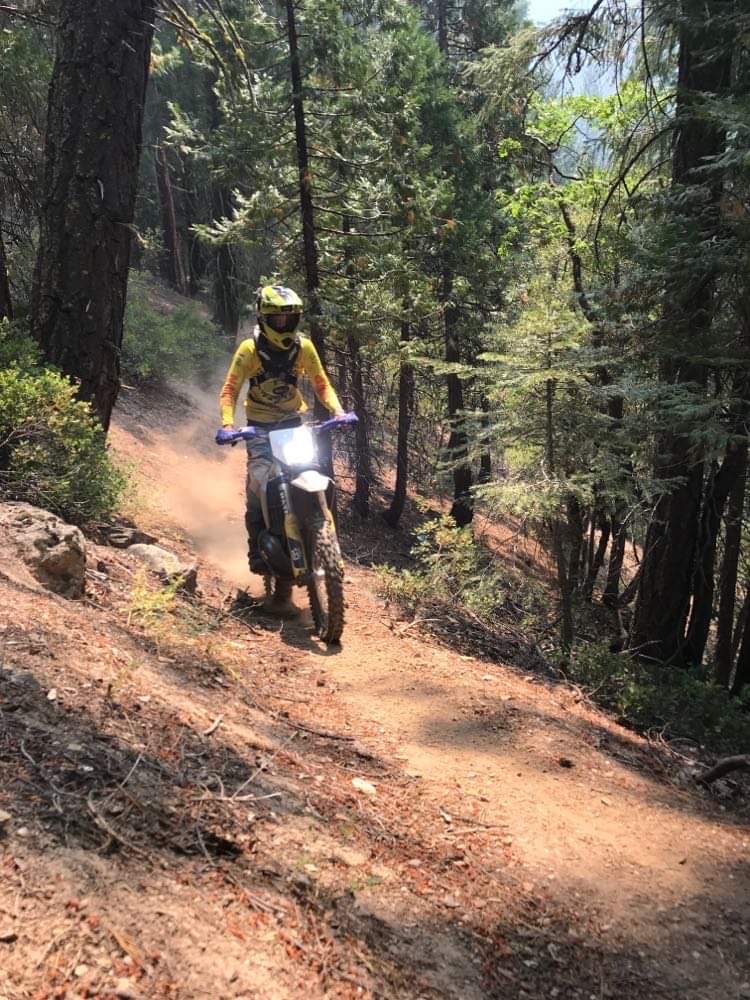dirtbike riding through forest